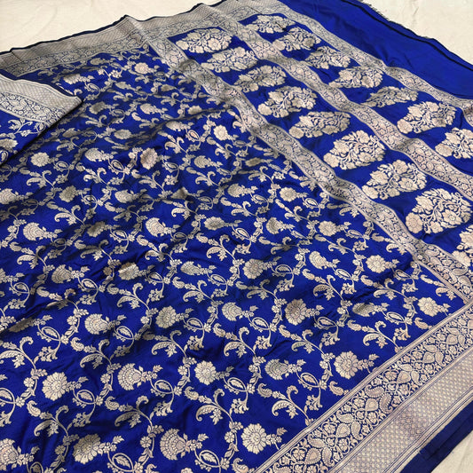 Blue saree with white floral patterns on a plain background